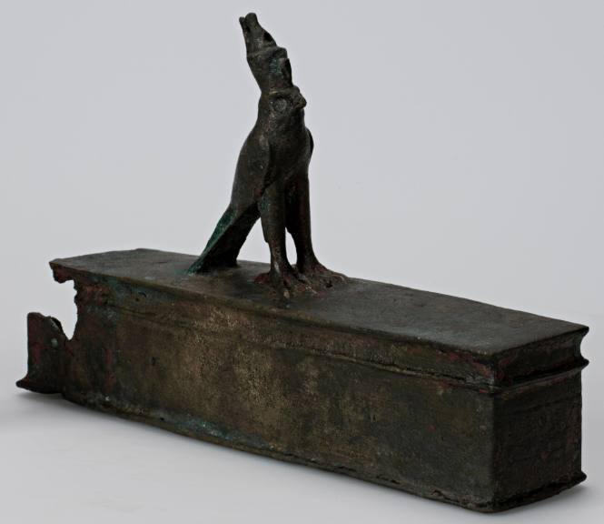 Sarcophagus surmounted by a figure of Horus wearing a double crown