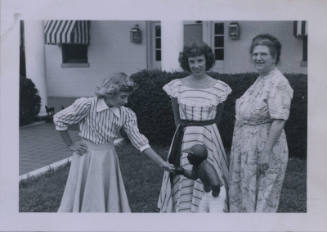 Untitled [Three women in a garden, two in stripes and one in a floral dress (from left to right)]