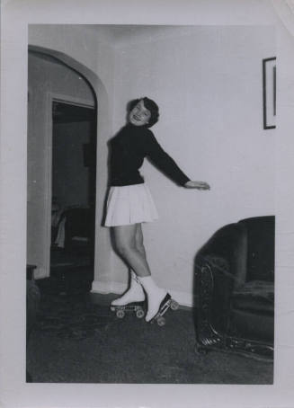 Untitled [Woman on roller skates leans back and lifts leg slightly from ground]