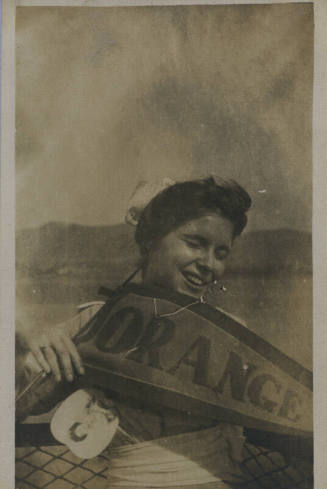 Untitled [Woman holds banner that reads ORANGE]