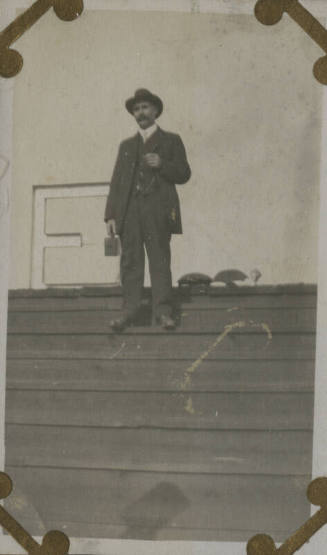 Untitled [Man stands on bleachers, holds camera (#87 duplicate)]