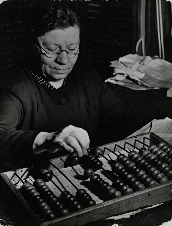 Russian woman using an abacus to calculate numbers in business