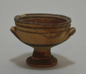 Kylix with angular profile, on foot ormanented with brown and red painted bands.
