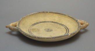 Plate with lateral handles, white painted ware with concentric circles in red and brown, and cross hatching design on exterior