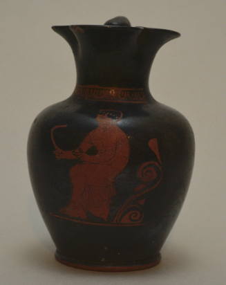 Red-figure trefoil-lipped oinochoe; decorated with seated youth holding a strigil