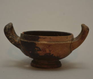 Black-glazed kylix with high-swung handles