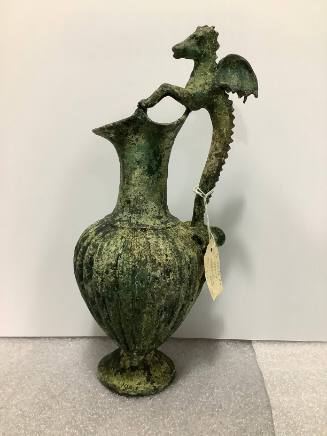 "Roman style" vase with ribbed body, trefoil mouth and handle in the form of a winged hoppocamp
