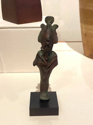 Statuette of Osiris, God of the Dead, with shepherd's crook and flail, wearing atef crown with sun disc