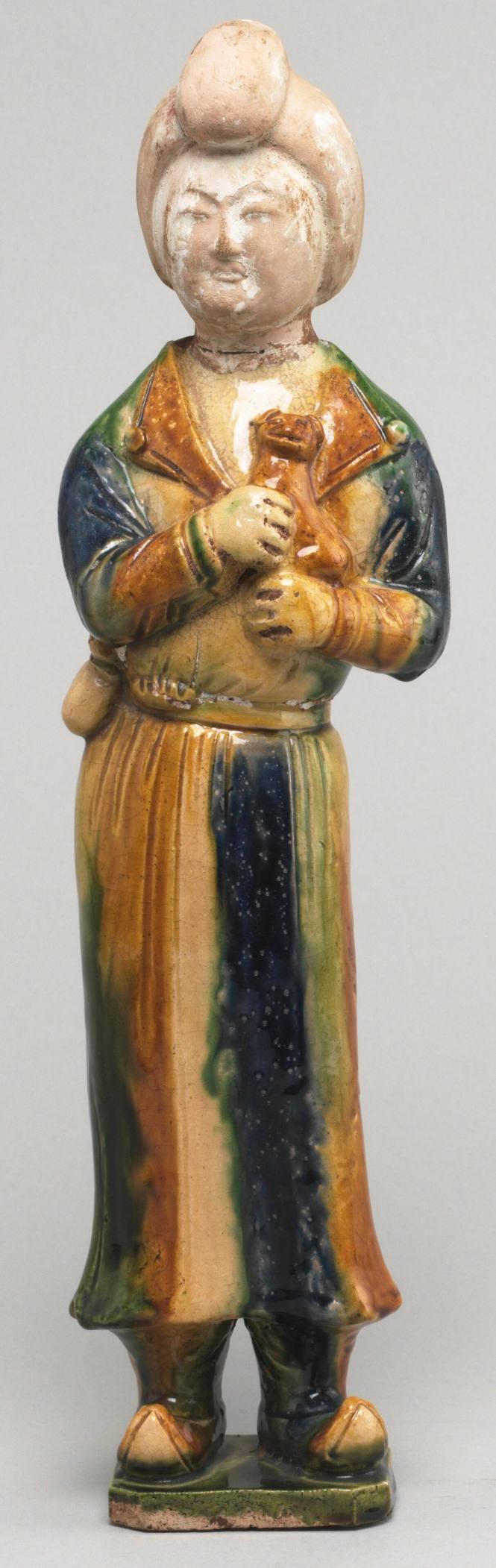 Tang style Chinese figure attendant standing holding a dog
