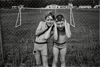 Ricky Boise and Tommy Cuddeback ‘exchanging heads’ at the soccer field next to the community swimming pool, Millerton, New York, from the series and book, A Kind of History
