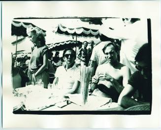 Bob Colacello, Jon Gould, and Fred Hughes at a Beachside Cafe, Deauville, France
