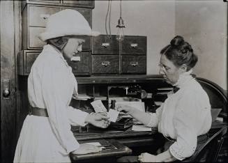 Untitled (Woman at desk with young girl)
