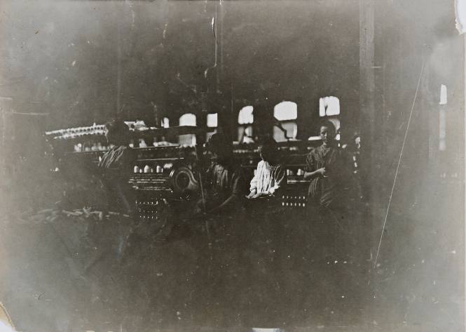 Lincoln Cotton Mills, Evansville, Indiana, Boy Sweeping and Small Girl Picking Up and Carting Away (Bad Light and Shaking Floors)