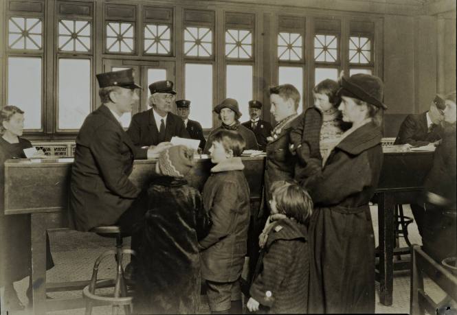 Interpreter and Recorder Getting Data from German Family [Ellis Island]