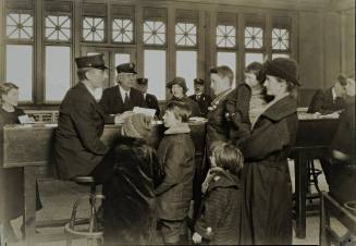 Interpreter and Recorder Getting Data from German Family [Ellis Island]