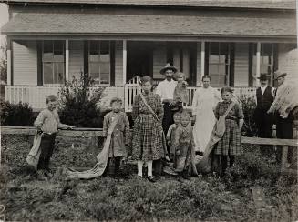 Untitled (Child laborers and parents in front of house)