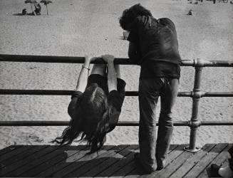 Untitled (Couple on boardwalk railing)