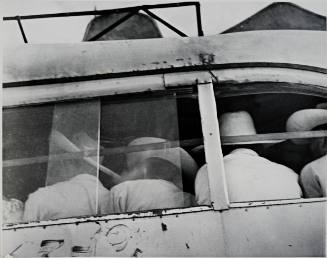 Untitled (Back of seated  men with white hats)