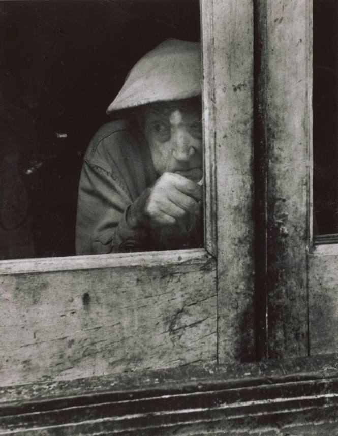 Untitled (Man peering out window)