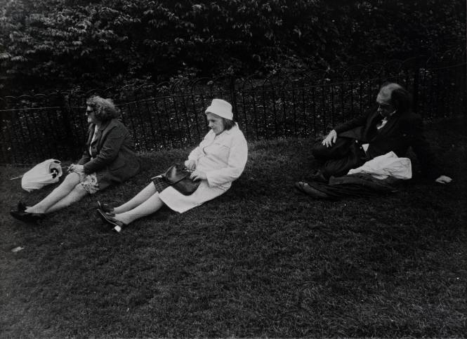 Untitled (Three people sitting on lawn facing left)