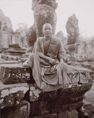 Monk Under a Lion, Bayon, Angkor Thom, Cambodia