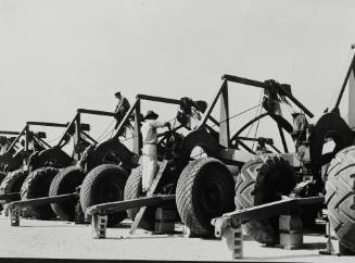 Army service forces loading heavy equipment