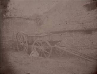 Child Sitting by a Hayrick