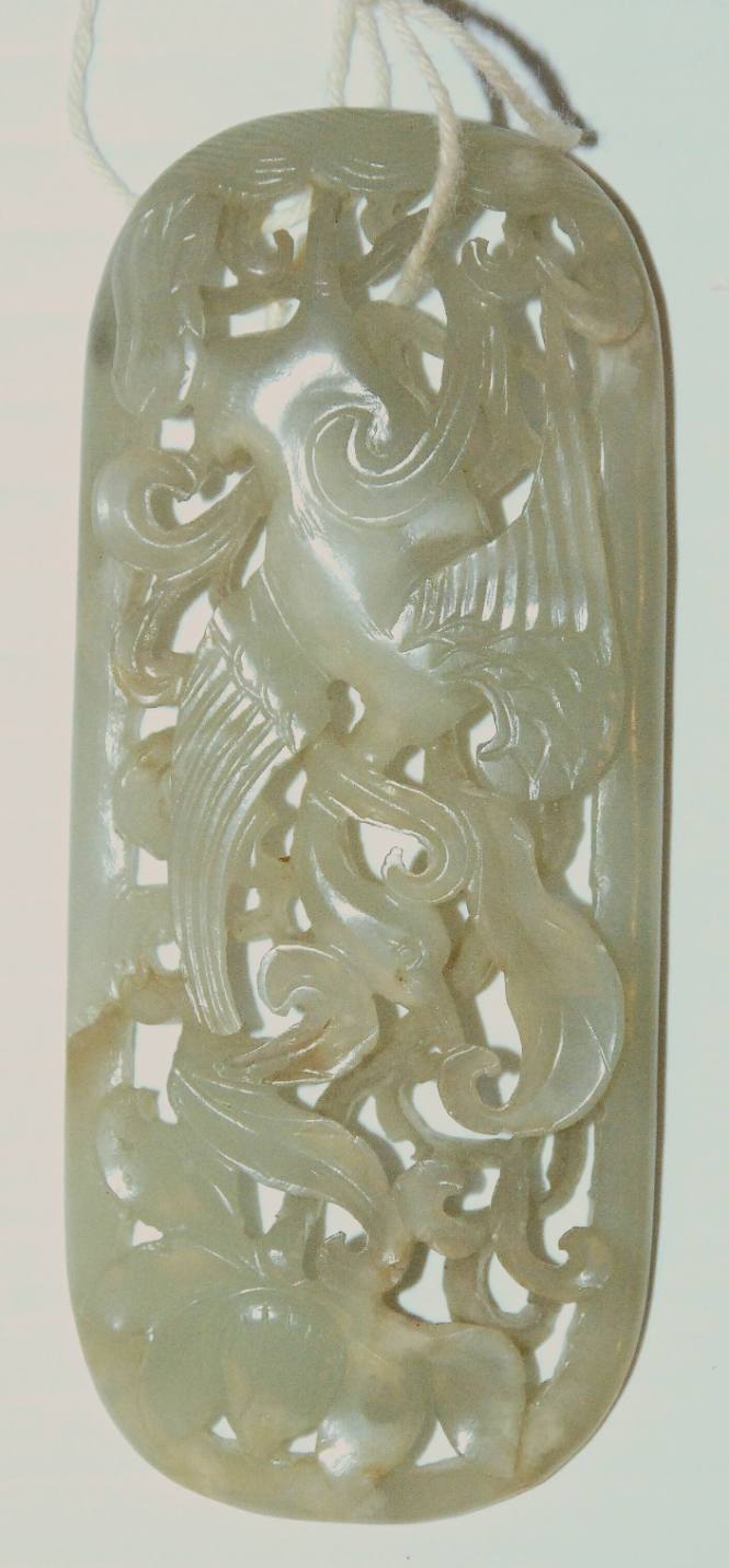 Jade reticulated scepter ornament of oval form carved with a crane in a lotus pond
