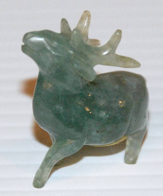 Jade statue of a deer with stocky short legs and a long tail