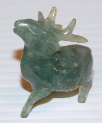 Jade statue of a deer with stocky short legs and a long tail