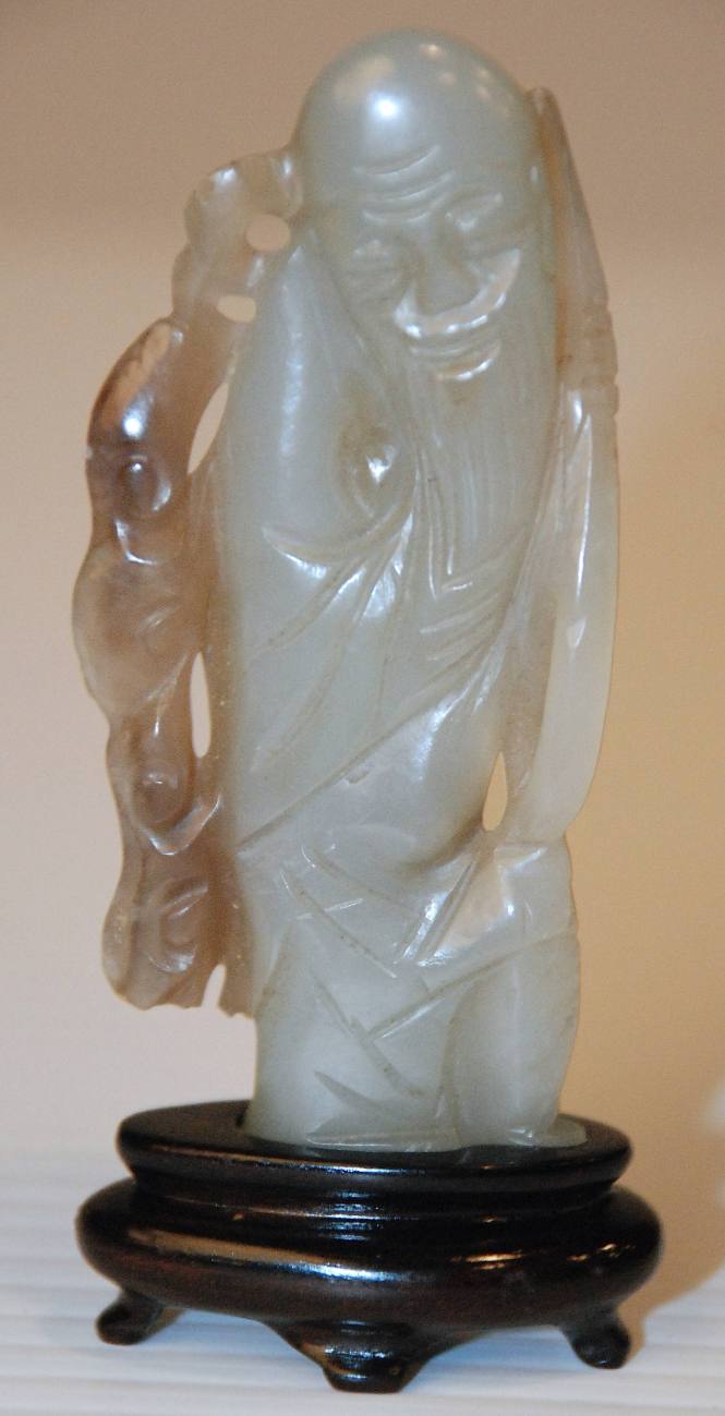 Jade pendant depicting a long bearded man holding a fungus spray "symbol of longevity"