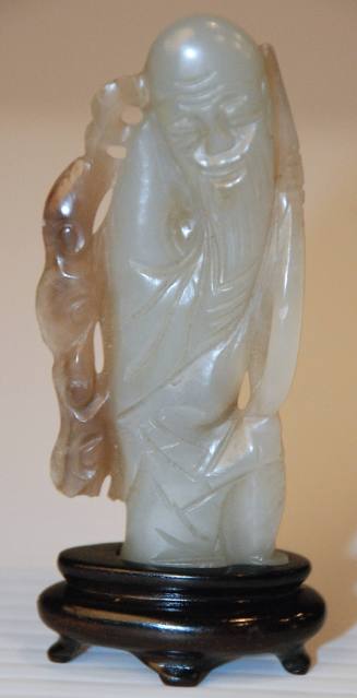 Jade pendant depicting a long bearded man holding a fungus spray "symbol of longevity"