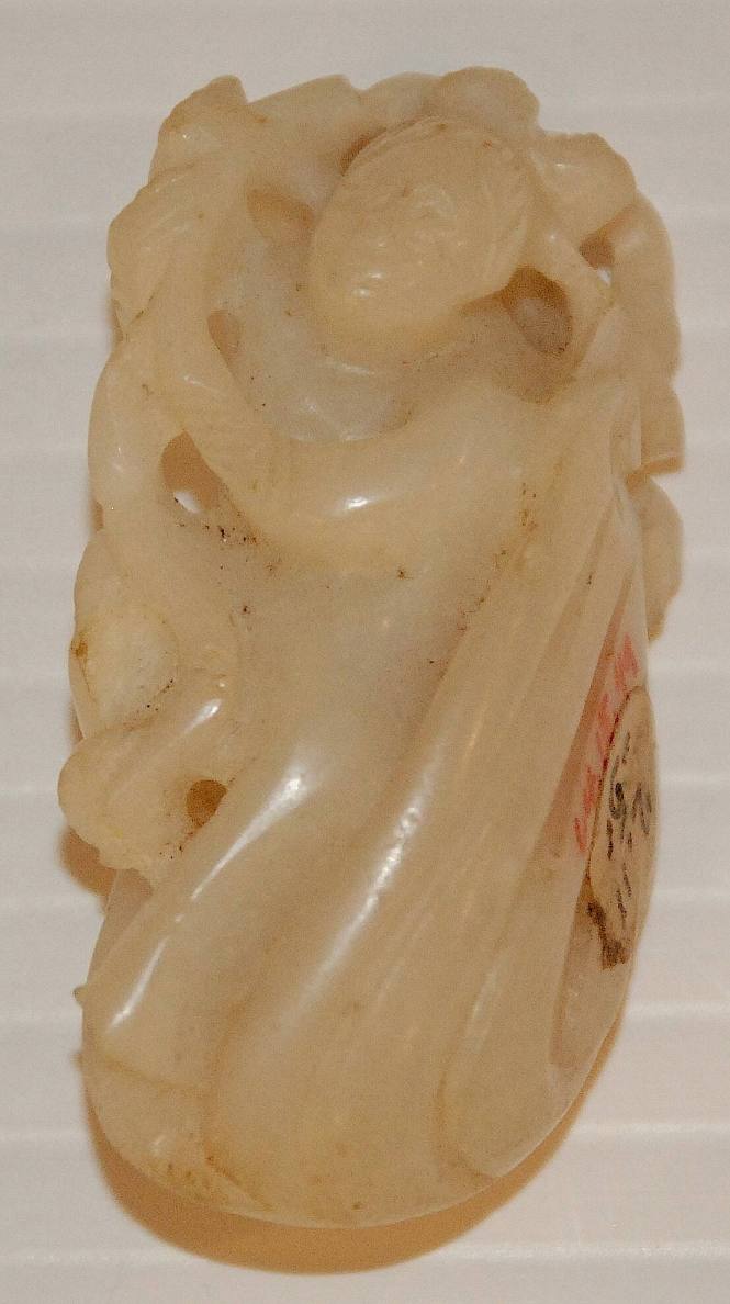 Jade fingering piece of child in a clam shell