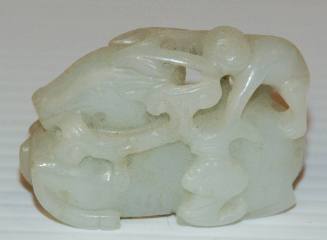 Jade toggle or with a monkey on the back of a reclining deer, holding a fungus spray with a flying bat