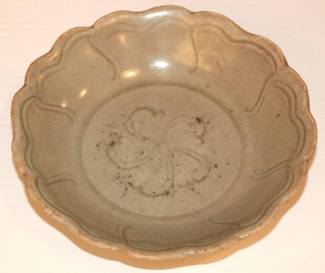 Celadon saucer, lotus form with incised design, floral center
