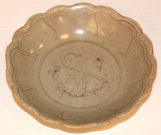 Celadon saucer, lotus form with incised design, floral center