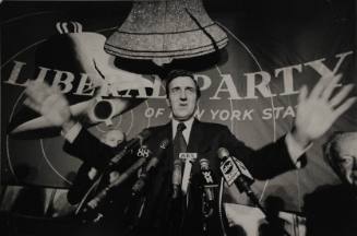 Ed Muskie in front of Liberal Party banner