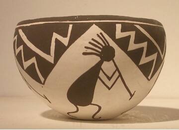 Black-on-white pot with four kokopelli figures