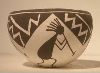 Black-on-white pot with four kokopelli figures