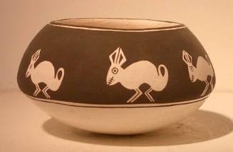 Black-on-white pot with white style rabbits on black area