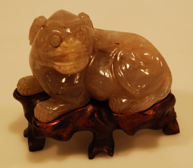 Agate reclining chimera with head turned to the left