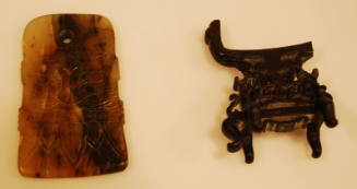 Agate axe pendant carved on both sides with t'ao and t'ieh masks fret band and palm leaves with wooden stand