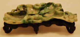 Jadeite brush washer in the form of a curled lotus leaf with bloom, stem and foliage