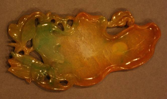 One of a pair of jadeite palettes in the form of a flattened lotus leaf with stem and foliage with a bee