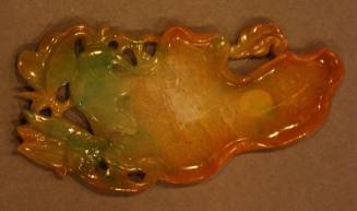 One of a pair of jadeite palettes in the form of a flattened lotus leaf with stem and foliage with a bee