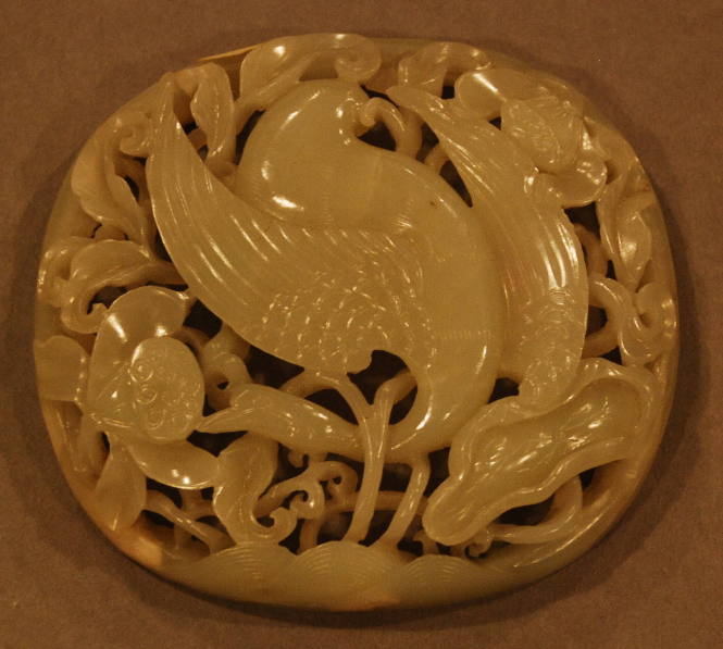 Jade reticulated scepter ornament carved in three dimensions depicting a crane in a lotus pond surrounded with lotus and water plants