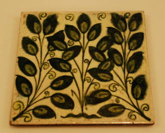 Light green ceramic tile with dark green floral design