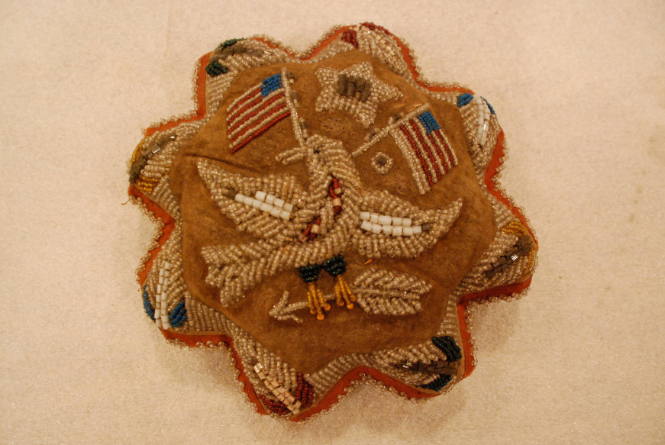 Pincushion with star above eagle holding arrow and two American flags