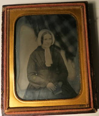 Seated Woman with Plaid Drapery Background