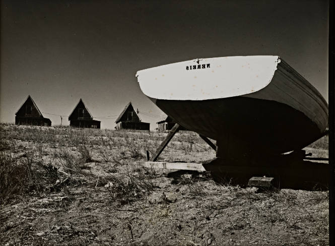 Rural landscape with boat and A-frame houses
